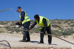 Arbeiter durchtrennen die Wasserleitungen in Masafer Yatta; Foto © EAPPI